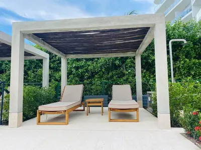 two chairs and a table under a gazebo at Fantastic Loft/Beachfront+Pools in Cartagena de Indias