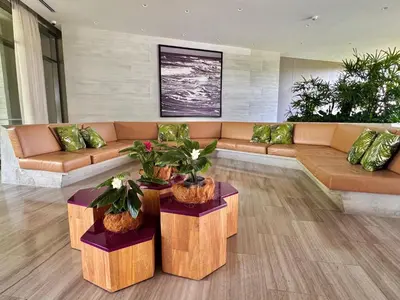 a living room with a couch and tables with plants at Fantastic Loft/Beachfront+Pools in Cartagena de Indias