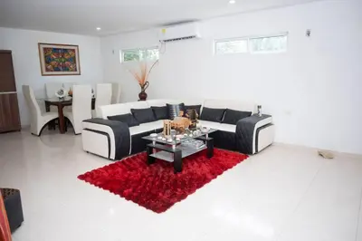 a living room with a couch and a red rug at cabaña villa Oti 1 in Ciénaga