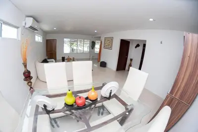 a living room with a glass table with fruits on it at cabaña villa Oti 1 in Ciénaga