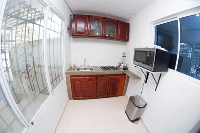 a small kitchen with a sink and a microwave at cabaña villa Oti 1 in Ciénaga