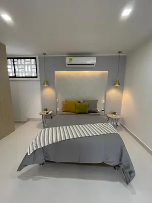a bedroom with a large bed with two side tables at Apartasuites Mardini in Cartagena de Indias