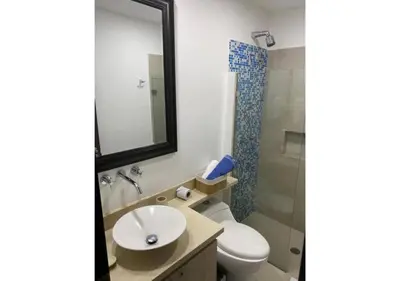 a bathroom with a toilet and a sink and a mirror at Apartamento frente al mar con vista única en Cartagena in Cartagena de Indias
