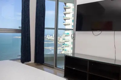 a bedroom with a bed and a large window at Apartamento frente al mar con vista única en Cartagena in Cartagena de Indias