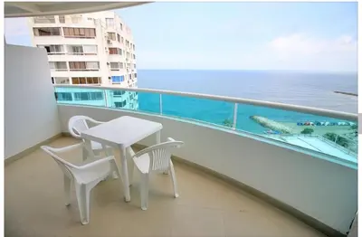 a balcony with a table and chairs and the ocean at Torres del lago de 2 habitaciones, 1201 in Cartagena de Indias