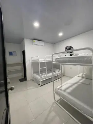 a room with three bunk beds and a hallway at HOTEL HOUSE San Antero Córdoba in San Antero