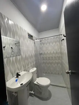 a bathroom with a toilet and a sink and a shower at HOTEL HOUSE San Antero Córdoba in San Antero