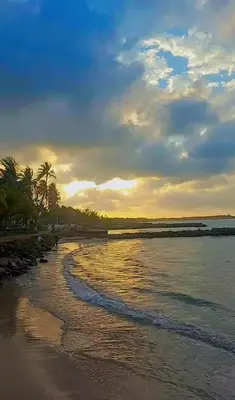 a beach with the sun setting on the water at HOTEL HOUSE San Antero Córdoba in San Antero