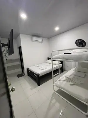 a room with two bunk beds and a tv at HOTEL HOUSE San Antero Córdoba in San Antero