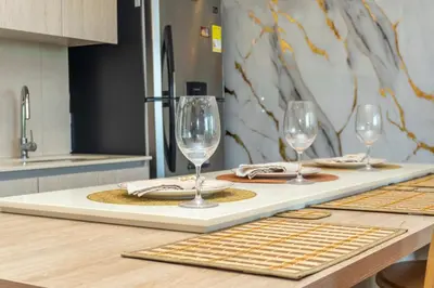 three wine glasses sitting on a table in a kitchen at Dominique Cartagena, Beautiful 2 Bedroom Apartment in Cartagena de Indias