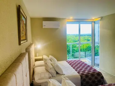 a bedroom with a bed and a large window at Dominique Cartagena, Beautiful 2 Bedroom Apartment in Cartagena de Indias
