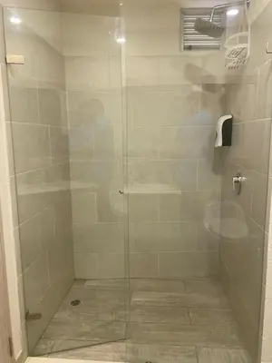 a shower with a glass door in a bathroom at Dominique Cartagena, Beautiful 2 Bedroom Apartment in Cartagena de Indias