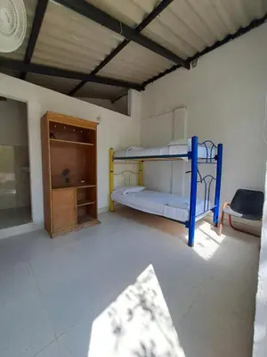 a room with two bunk beds and a cabinet at Mar Rosa Galerazamba Hostal in Galerazamba