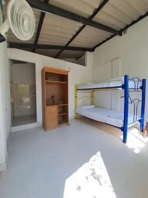 a room with two bunk beds and a fan at Mar Rosa Galerazamba Hostal in Galerazamba