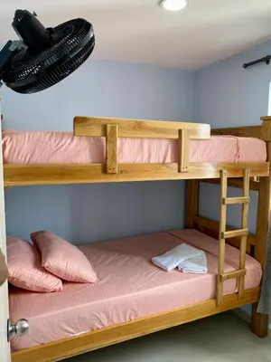 two bunk beds in a room with pink sheets at Apartamento en Cartagena, Entero y Amueblado in Cartagena de Indias