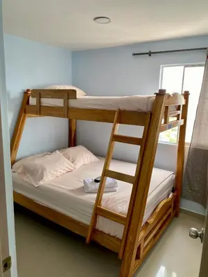two bunk beds in a room with a window at Apartamento en Cartagena, Entero y Amueblado in Cartagena de Indias