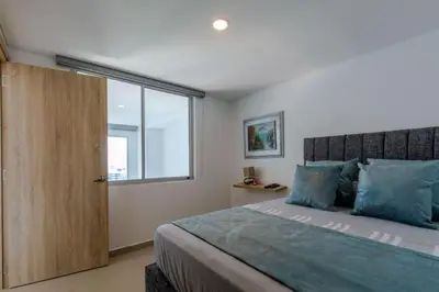 a bedroom with a large bed and a window at APARTAMENTO EDIFICIO MONTU in Cartagena de Indias