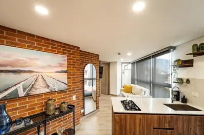 a kitchen with a large painting on the wall at Apartamento ubicado en, LAURELES, MEDELLIN in Cartagena de Indias