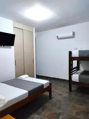a small room with two beds and a ladder at SGH Hotel Palm Bay Bello Horizonte in Santa Marta