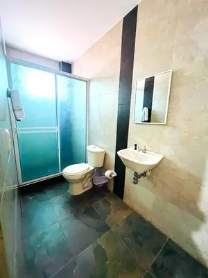 a bathroom with a toilet and a sink at SGH Hotel Palm Bay Bello Horizonte in Santa Marta