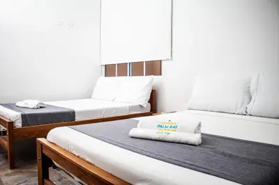a small room with two beds and a couch at SGH Hotel Palm Bay Bello Horizonte in Santa Marta