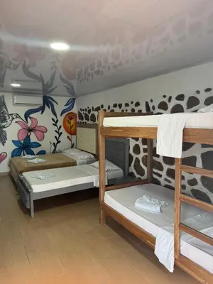 a dorm room with three bunk beds in it at Ecohotel La Reserva in Piojó