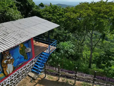 a house with a painting on the side of it at Ecohotel La Reserva in Piojó