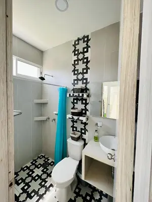 a bathroom with a white toilet and a sink at AzulRest Casa de Verano in Santa Veronica