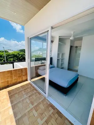 a bedroom with a balcony with a bed and a tub at AzulRest Casa de Verano in Santa Veronica