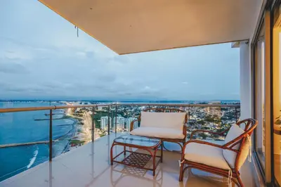 a balcony with a chair and a view of the city at SkyMar Luxury 27 in Cartagena de Indias
