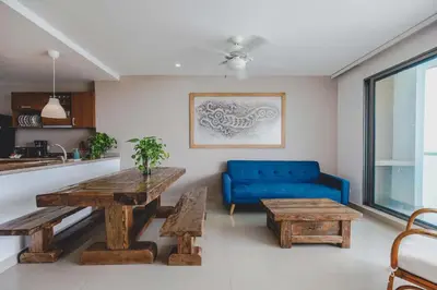 a living room with a table and a blue couch at SkyMar Luxury 27 in Cartagena de Indias