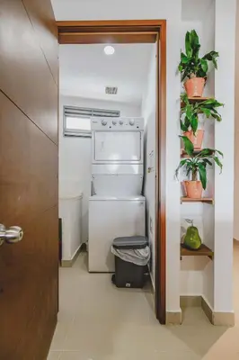 an open refrigerator in a hallway with plants at Frente Al Mar Ciudad Antigua Home Office 14B in Cartagena de Indias