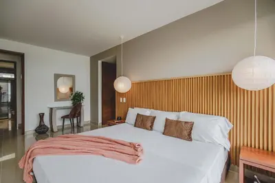 a bedroom with a large white bed and two pendant lights at Frente Al Mar Ciudad Antigua Home Office 14B in Cartagena de Indias