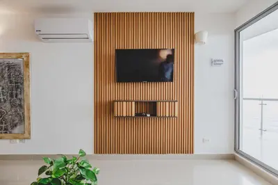 a living room with a television on a wall at Frente Al Mar Ciudad Antigua Home Office 14B in Cartagena de Indias