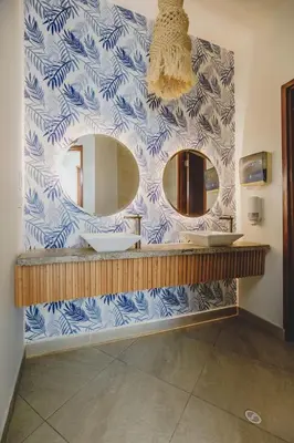 a bathroom with a sink and two mirrors at Frente al Mar home office 7B in Cartagena de Indias