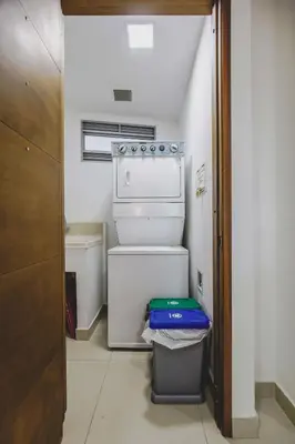 a small kitchen with a stove and a trash can at Frente al Mar home office 7B in Cartagena de Indias