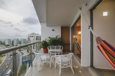 a balcony with a table and chairs on a balcony at Frente al Mar home office 7B in Cartagena de Indias