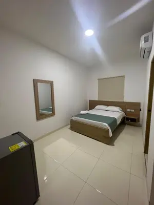 a bedroom with a bed and a mirror at Hotel Mariscales Sincelejo in Sincelejo