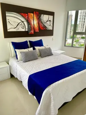 a bedroom with a large blue and white bed at Apartamento con espectacular vista al oceano in Cartagena de Indias