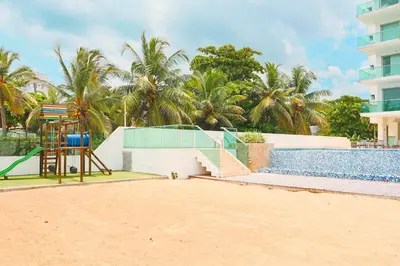 a playground next to a swimming pool next to a building at Magico Apartamento Frente al Mar 3 Habitaciones TR21 in Coveñas