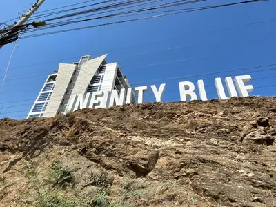 a sign for a mer infinity building on a hill at Infinity Blue - Playa Dormida in Santa Marta
