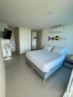a bedroom with a bed and a tv in it at Infinity Blue - Playa Dormida in Santa Marta