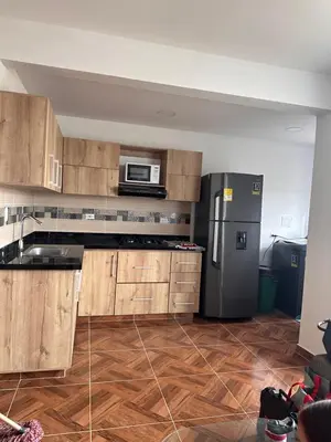 a kitchen with wooden cabinets and a stainless steel refrigerator at 