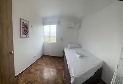 a small room with a bed and a window at 