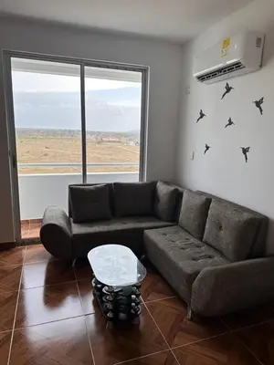 a living room with a couch and a window at 