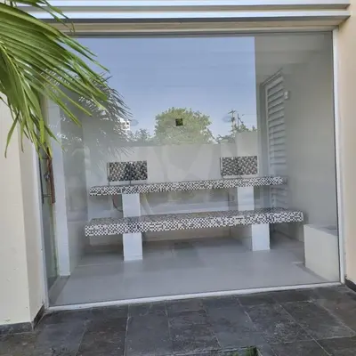 a white bench sitting inside of a window at Torres del Mar Santa Marta in Santa Marta