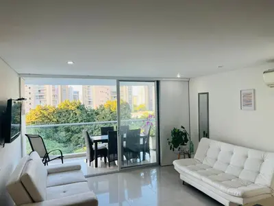 a living room with a white couch and a table at Torres del Mar Santa Marta in Santa Marta