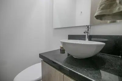 a bathroom with a white bowl sink on a counter at Great apartment in Bocagrande with sunset & beach view in Cartagena de Indias