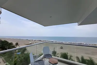 a balcony with chairs and a view of the beach at 2 Dormitorios Morros. Vista Mar y salida playa in Cartagena de Indias