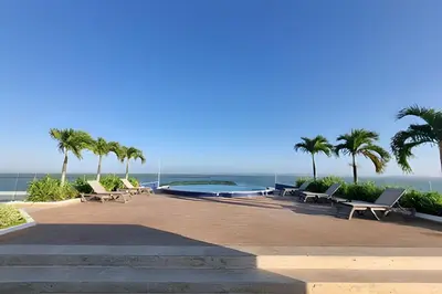a resort with a swimming pool and palm trees at 2 Dormitorios Morros. Vista Mar y salida playa in Cartagena de Indias